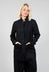 lady wearing a black caren jacket with full button fastening and front pockets