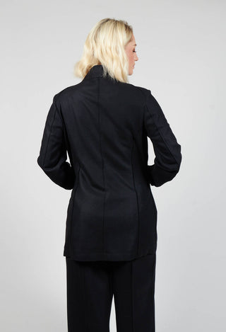 behind shot of lady wearing a black jacket and black trousers