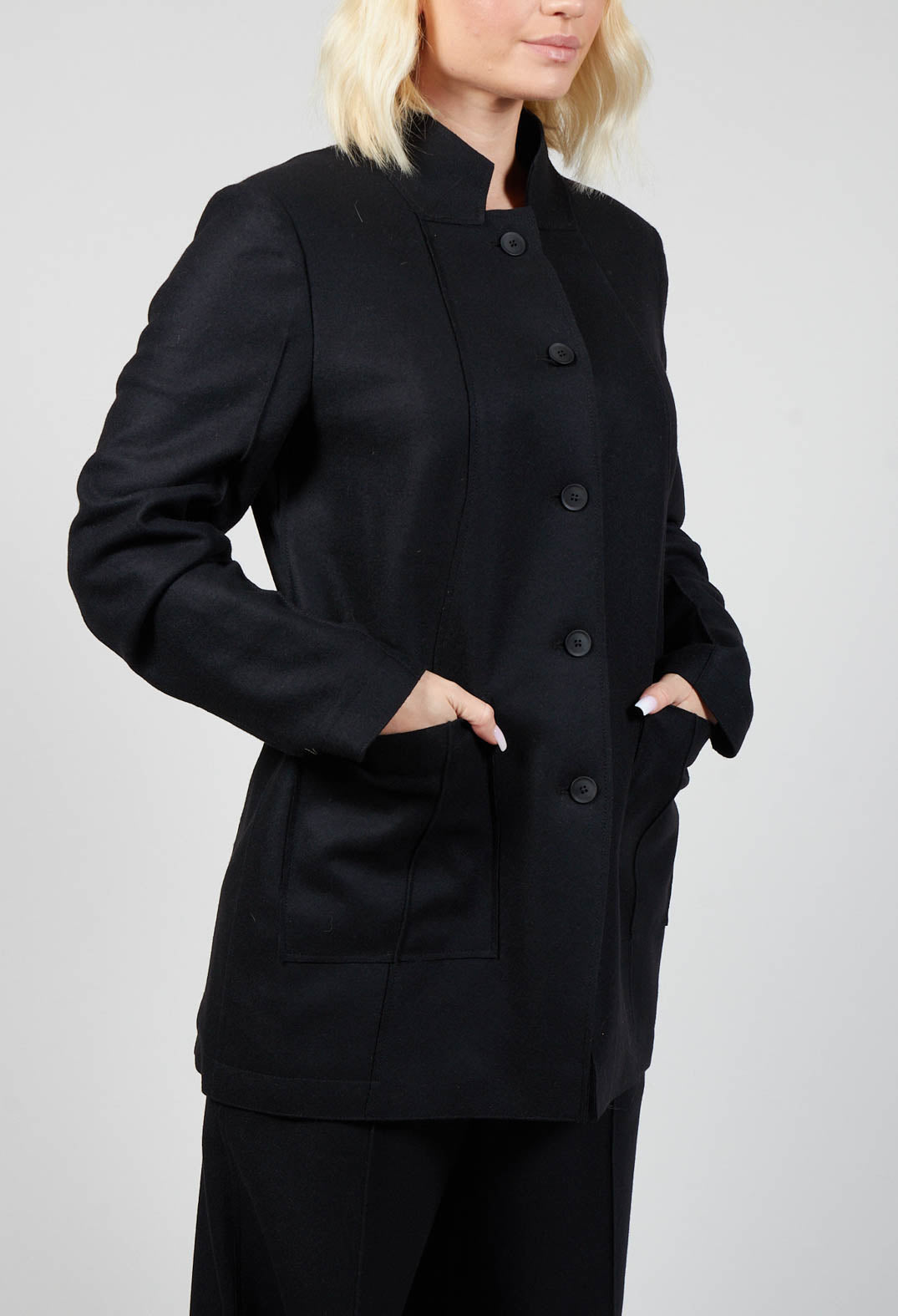 close up shot of a black jacket with buttons and front pockets