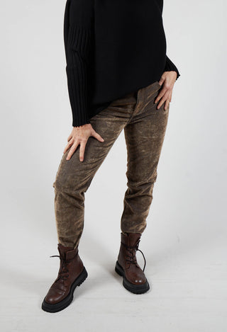 lady wearing brown ola trousers with black sweater and chunky brown boots