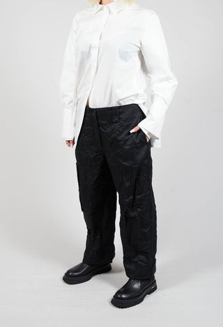 person wearing black peka trousers with their hand in a side pocket