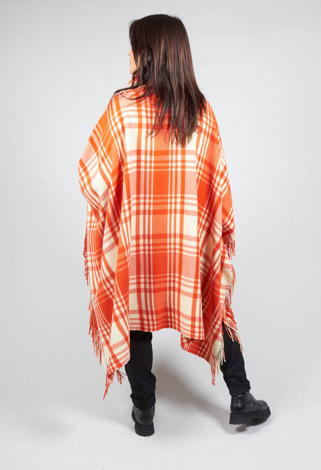 lady wearing a red checkered wool cape